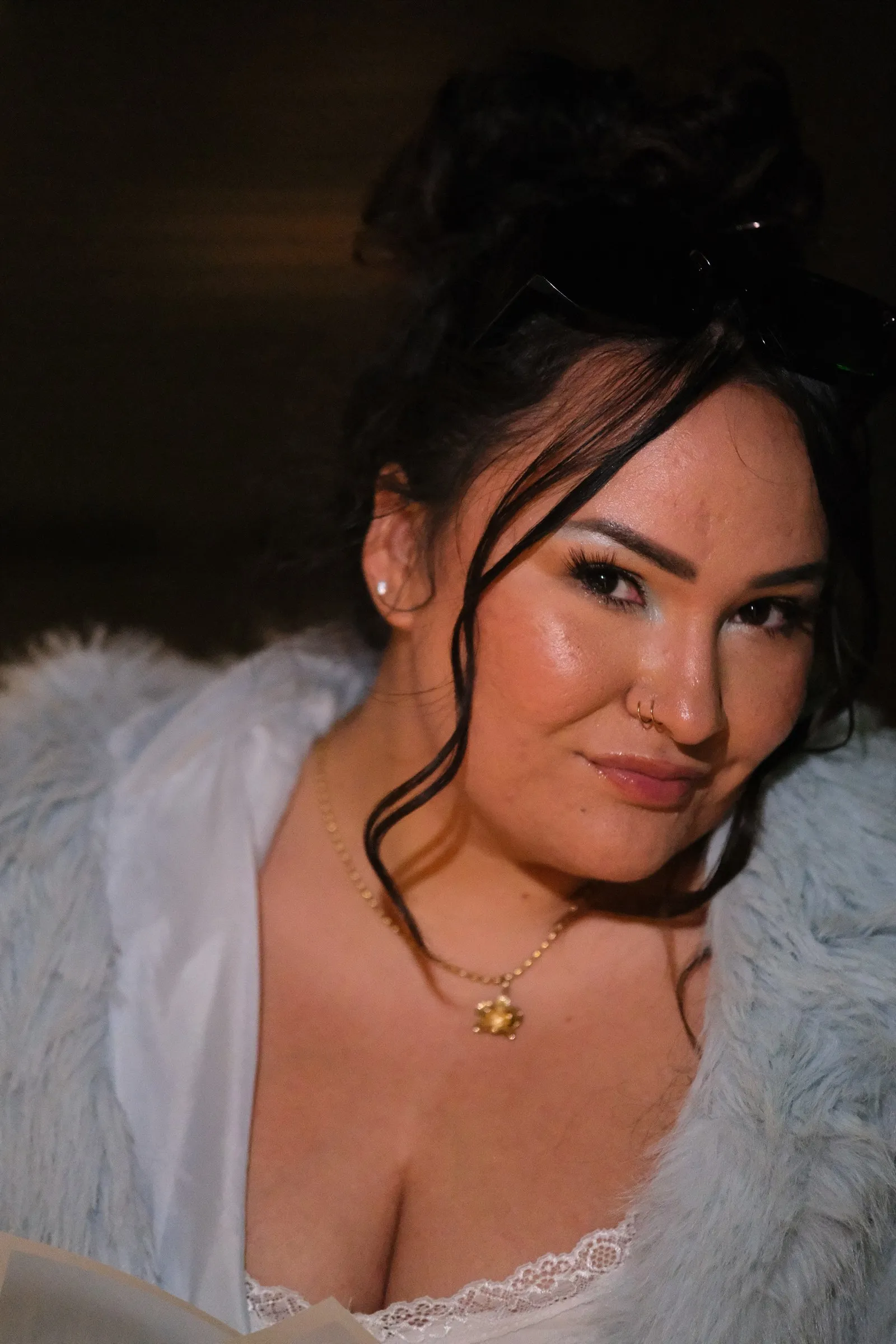 Amanda in a pale blue fur coat and gold pendant, photographed at night on her 28th birthday.